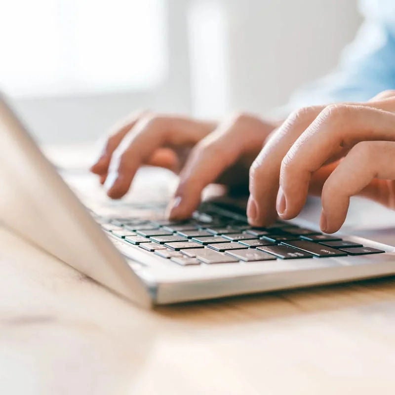 Person typing on a laptop